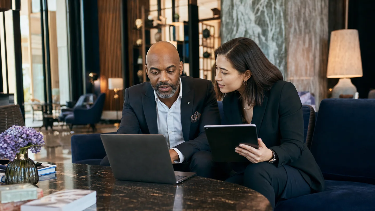 Hotel management team reviewing hotel website content and the mobile guest journey
